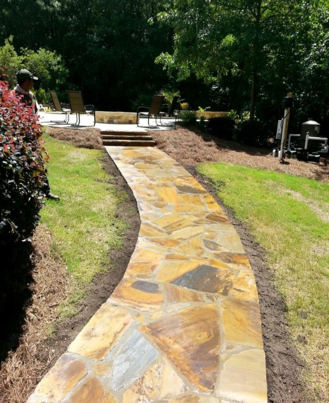 Natural flagstone walkway leading up steps to a pool patio
