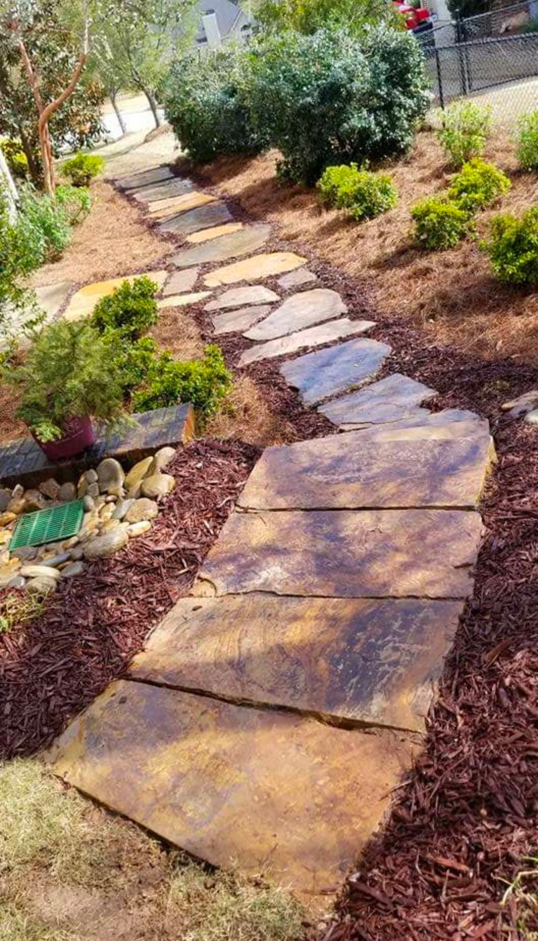 Natural flagstone walkway winding down a planted slope