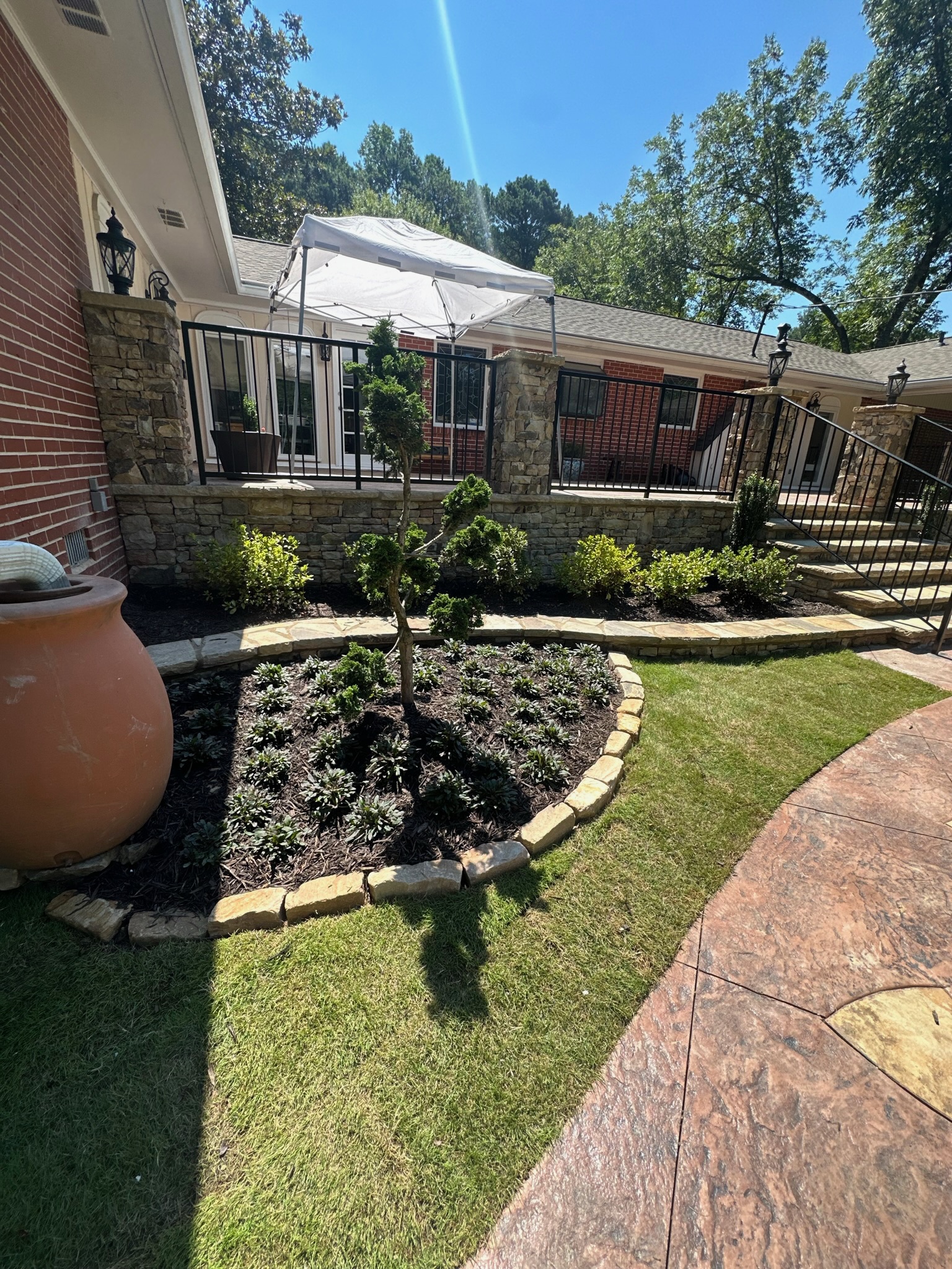 Backyard with stone retaining walls and sod